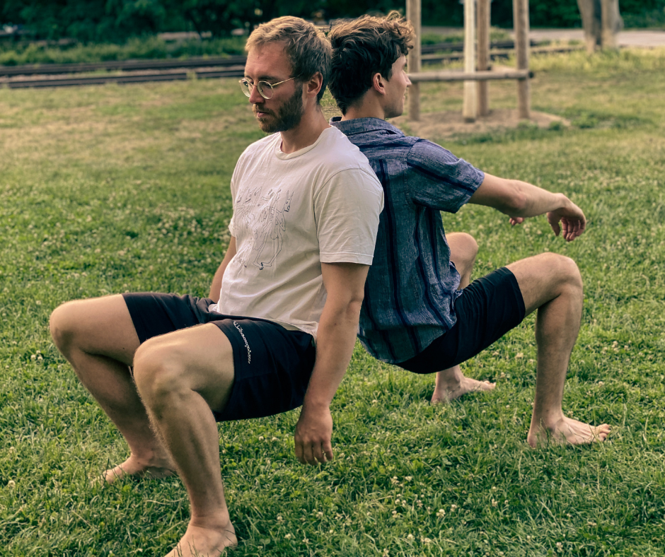 two people leaning into each other back to back doing a squat as partner exercise